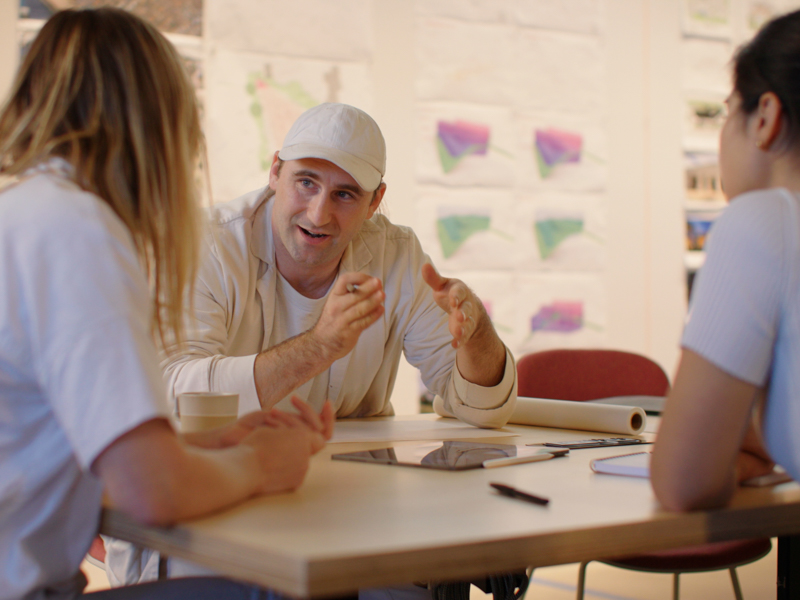 Photo of Stephen Kenn collaborating and speaking to other team members